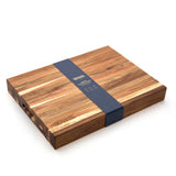 Wooden cutting board with a blue band on a white background