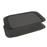 Two black griddle pans stacked on a white background