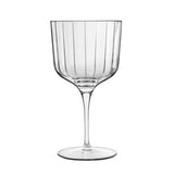 Clear glass cocktail gin glass with vertical stripes on a white background