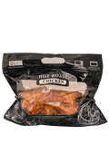Packaged hot roast chicken in a clear plastic bag with a black exterior on a white background.