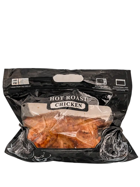 Packaged hot roast chicken in a clear plastic bag with a black exterior on a white background.