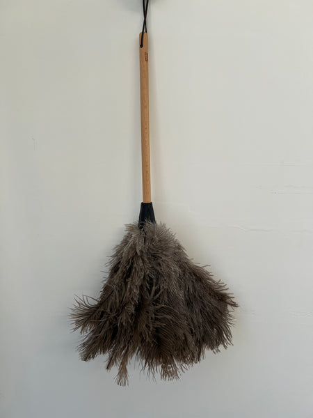 Duster with wooden handle on a white background