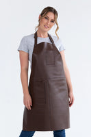A person wearing a brown leather apron with pockets, featuring a neck loop and waist ties.