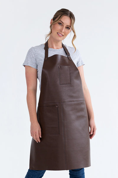 A person wearing a brown leather apron with pockets, featuring a neck loop and waist ties.