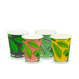 A set of three disposable paper cups with different colored leaf patterns on a white background.
