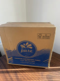 A large cardboard box of Pure Premium Blue centrefeed towels, 1 ply 300 metres, 4 rolls per carton, placed on a wooden table against a white wall.