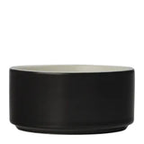 A matte black ceramic bowl with a contrasting light gray interior, shown from a side profile view on a plain white background.