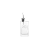 Clear glass oil bottle with black cap on a white background
