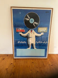 Framed poster with a stylized person holding a record and radio, on a blue background.